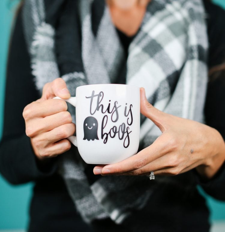 A close up of a person holding a cup, with decal of a ghost and the saying, \"This is Boos\"