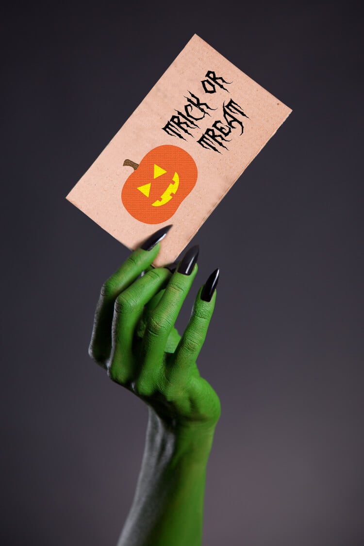 Image of a witch hand holding an invitation card with the free files