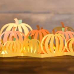 Paper cut pumpkin luminaria