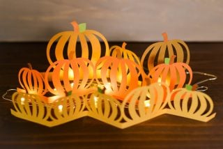 Paper cut pumpkin luminaria