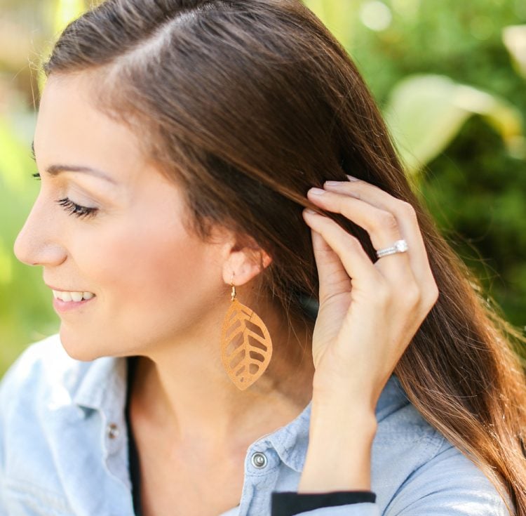 Woman wearing leather leaf earrings