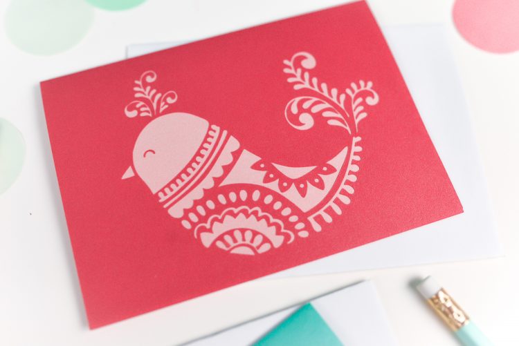 A close up of a card with a bird design on it