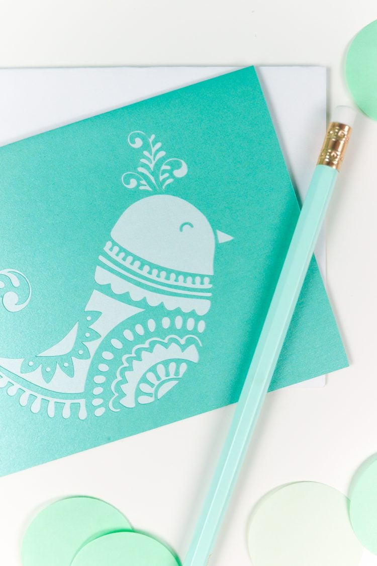 Close up of a pencil and a card with a bird design on it