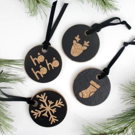 Four cork ornaments with greenery.
