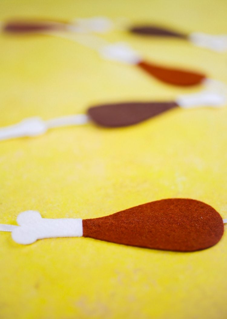 Close up of several turkey drumsticks cut out of brown and white felt
