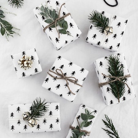 Presents wrapped in white paper with little trees on it