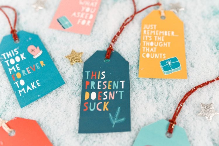 Christmas gift tags that say, \"This Present Doesn\'t Suck\", \"Just Remember It\'s the Thought That Counts\" and \"This is Just What You Asked For\"