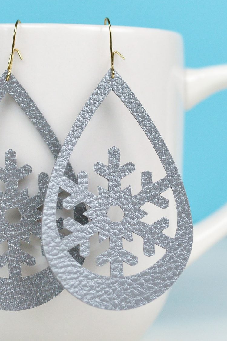 Close up of a pair of snowflake design earrings 