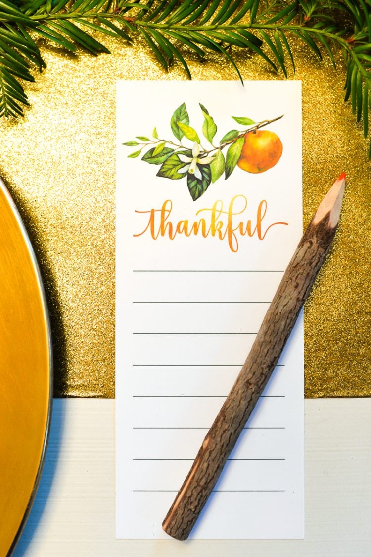 A pen sitting on top of a piece of paper with the word \"Thankful\" on it