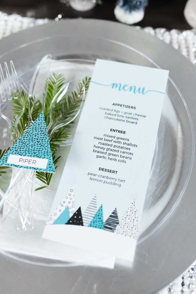 A place setting with a place card and a printed menu on top