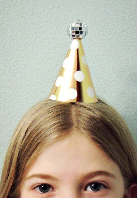 A little girl wearing a mini disc ball hat