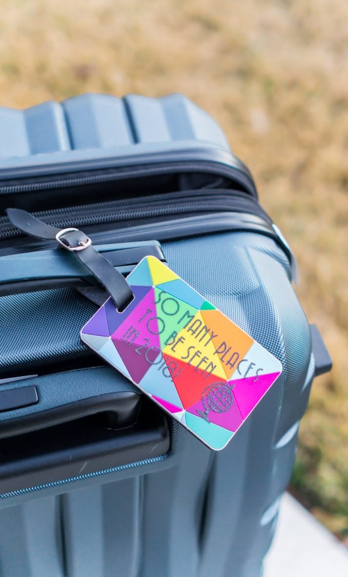 A piece of luggage with a luggage tag that says, \"So Many Places to be Seen in 2018!\"