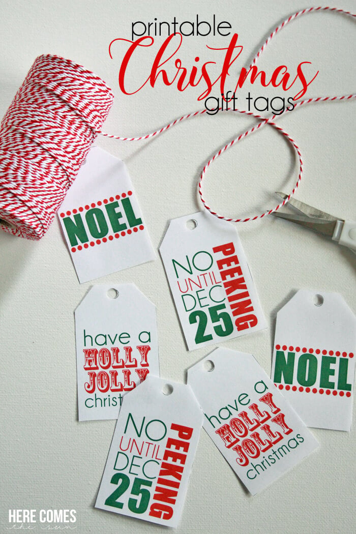 Red and white striped twine, a scissors and Christmas gift tags