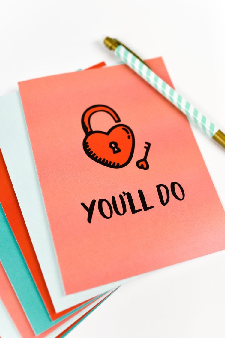 A close up of a pen and a greeting card that says, \"You\'ll Do\"