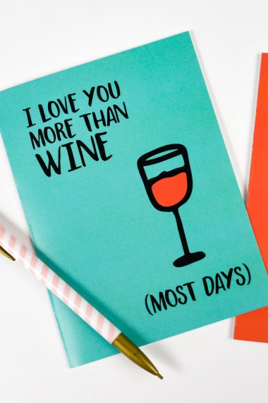 A pen and a greeting card that says, "I Love You More Than Wine.....(Most Days)"