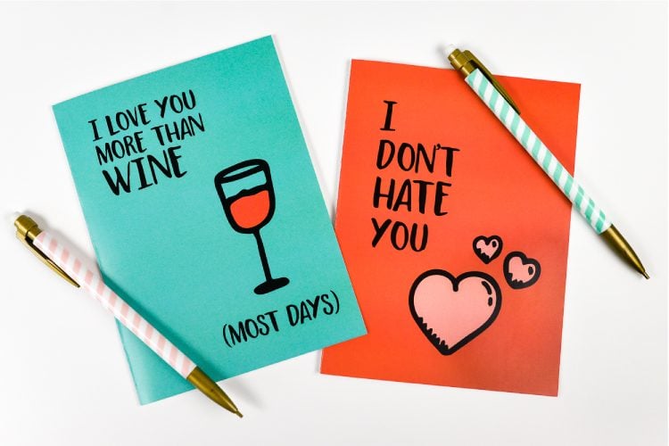 Two pens and two greeting cards that say, \"I Love You More Than Wine.....(Most Days)\" and \"I Don\'t Hate You\"