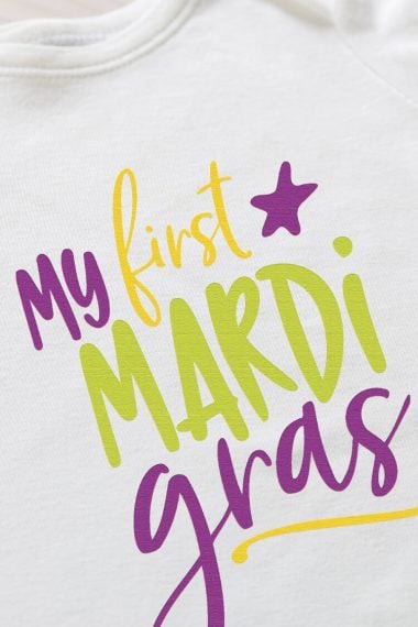 A white shirt with the saying, "My First Mardi Grads" on it
