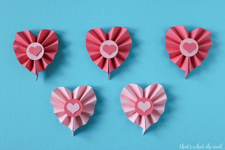 Several paper cut hearts against a blue background