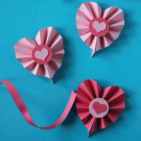 Use the scoring capabilities of your Cricut Explore or Maker to craft these Paper Rosette Hearts for Valentine's Day! The Cricut makes it easy to make these cute Valentine's Day decorations. 