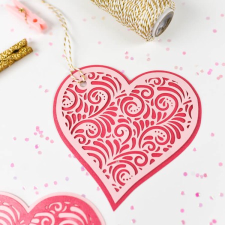 These intricate two-layer cut paper hearts, made on the Cricut or other cutting machine, are a beautiful addition to Valentine's Day gifts and Valentine's Day decor.