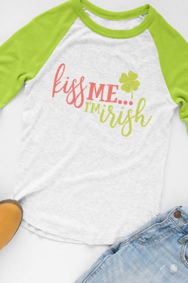 Blue jeans and a baseball style shirt with lime green sleeves and decorated on the body of the shirt with a shamrock and the saying, "Kiss Me.....I'm Irish"