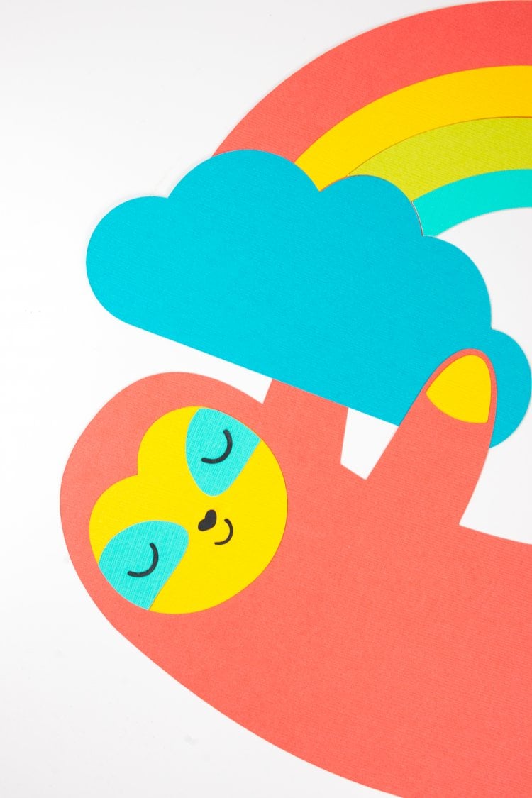 Close up of an uploaded image in Cricut Design Space of a sloth hanging on to clouds and a rainbow