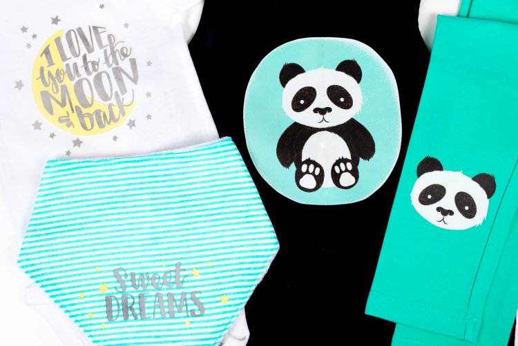 Close up of baby clothes decorated with panda bears and the sayings, \"Sweet Dreams\" and \"I Love You to the Moon and Back\"