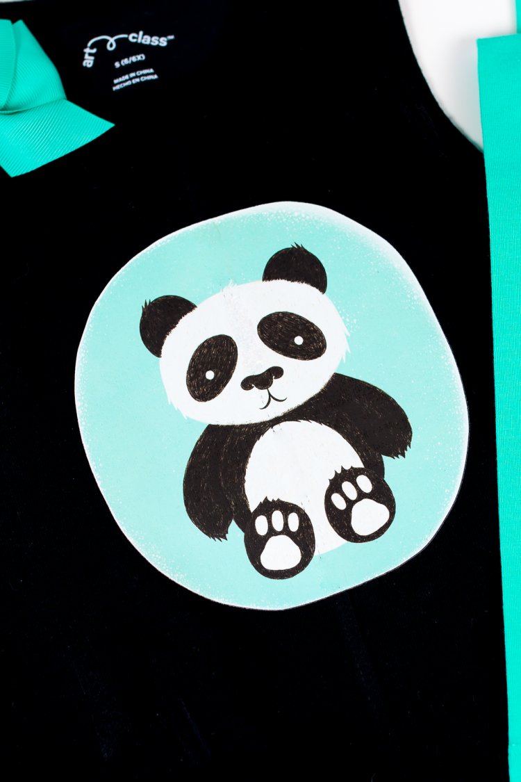 A panda on a piece of black material