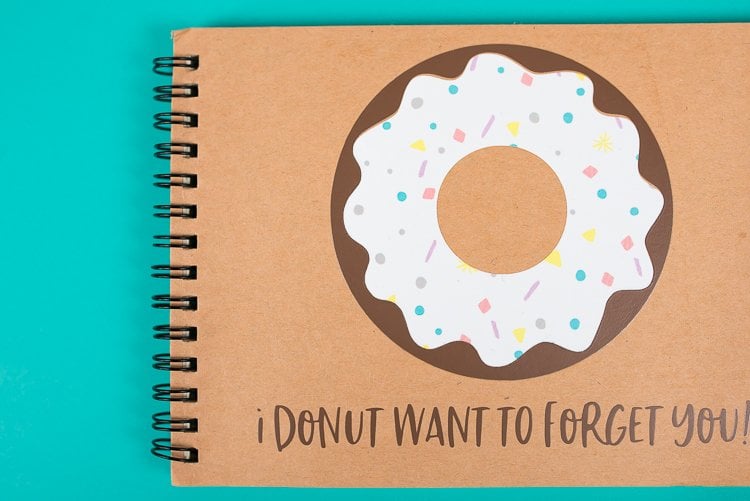 A close up of a journal with an image of a donut on it and text that says, \"I Donut Want to Forget You!\"