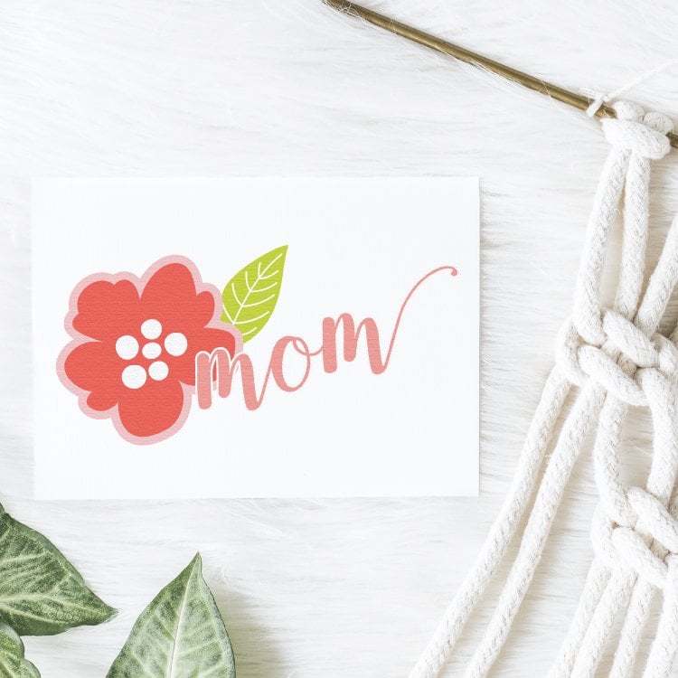 An image of a rose and the text \"Mom\" on a piece of white paper