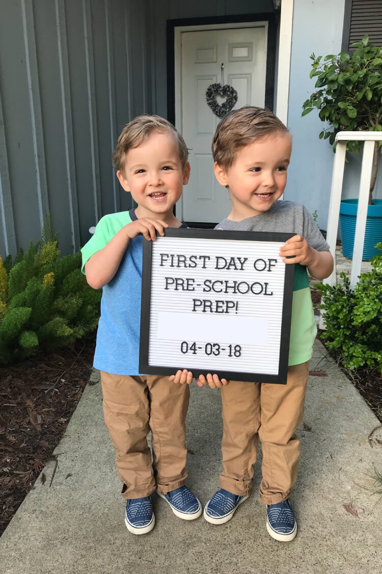 Two adorable little boys holding a sign that says, \"First Day of Pre-School Prep!\" with a dart of 04-03-18