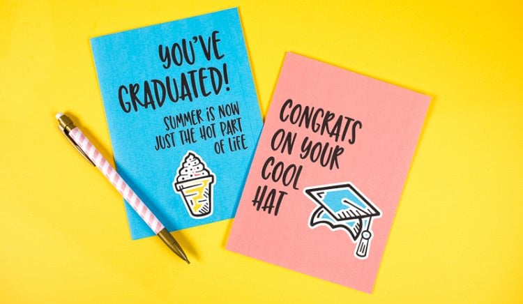 A pen and two greeting cards, one that says, \"Congrats on Your Cool Hat\" and the other says, \"You\'ve Graduated!  Summer is Now Just the Hot Part of Life\"