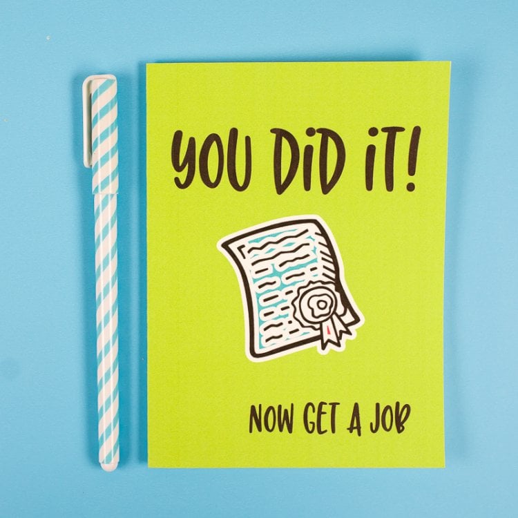 A pen and a graduation card that says, \"You Did It! Now Get a Job\"