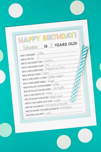 A pen and a piece of paper with a printed birthday questionnaire on it