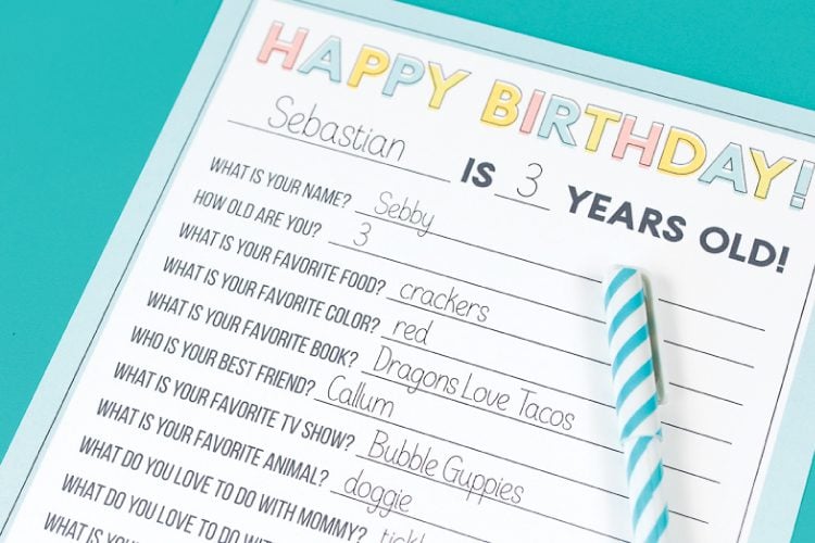 Close up of a pen and a piece of paper with a printed birthday questionnaire on it