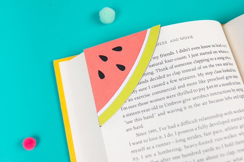 A book with a paper bookmark made out of a watermelon design