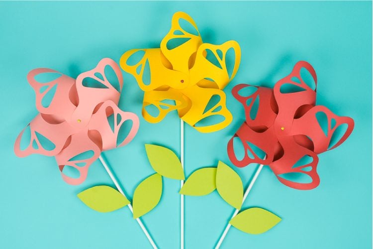 Flower paper pinwheels are beautiful for wedding and party decor, summer parties, and nursery decorations. Echoing butterflies and a little fancier than traditional pinwheels, they can easily be made using you Cricut or other cutting machine!
