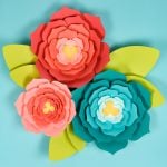 A close up of three paper flowers