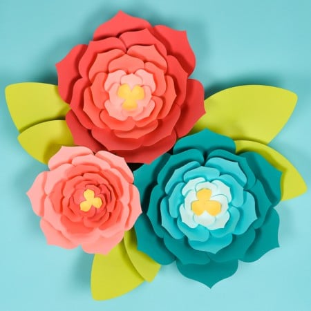 A close up of three paper flowers