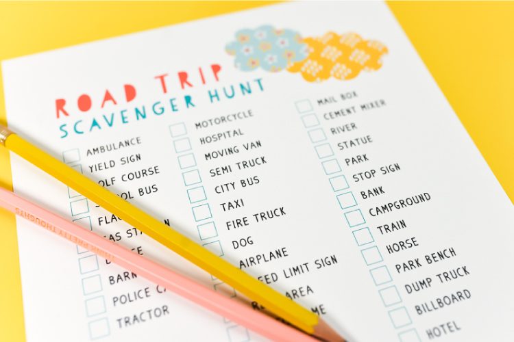Close up of two pencils on top of a sheet of paper that lists items for a road trip scavenger hunt