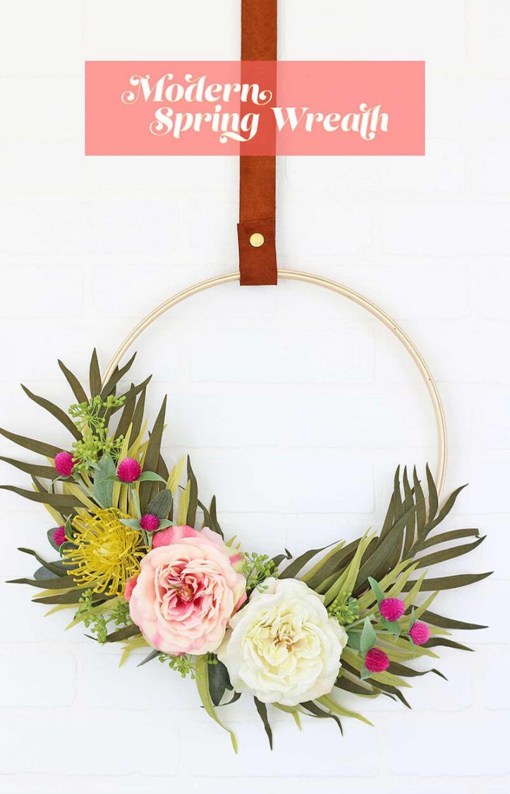 A spring wreath hanging on a wall 