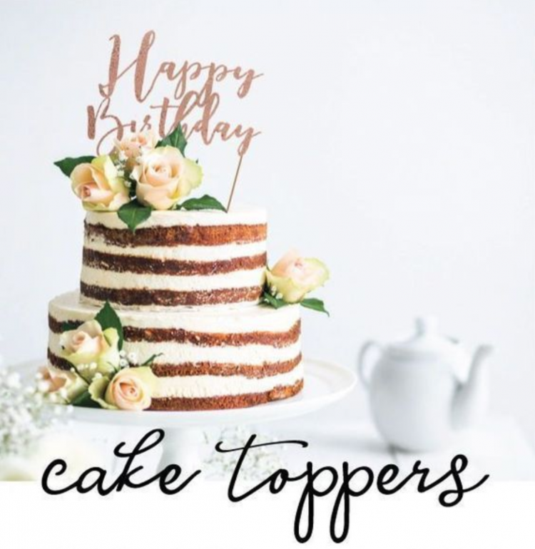 A cake sitting on top of a table with a cake topper that says, \"Happy Birthday\"