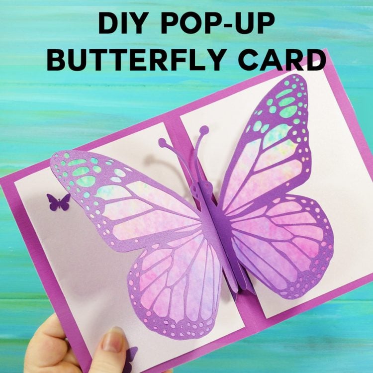 A hand holding a greeting card with advertising for a DIY Pop-Up Butterfly Card