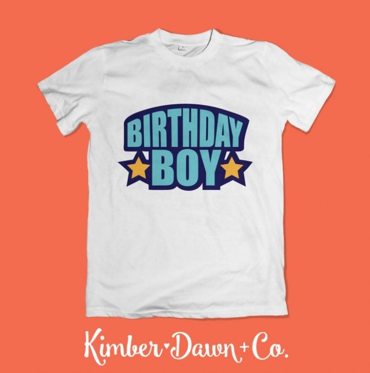 A white t-shirt decorated with the text, \"Birthday Boy\" and advertised by Kimber Dawn + Co.