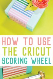 An image of a box wrapped in multicolored striped paper and a paper rose on top of it and the Cricut scoring wheels with advertising on how to use the Cricut scoring wheel by HEYLETSMAKESTUFF.COM