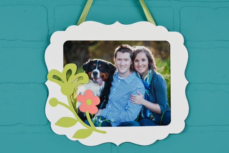 Picture of a man, woman and a dog that is in a frame made out of matboard