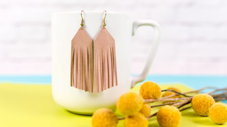 Create these trendy DIY suede fringe earrings! Use faux suede and your cutting machine to add these stylish earrings to your wardrobe.