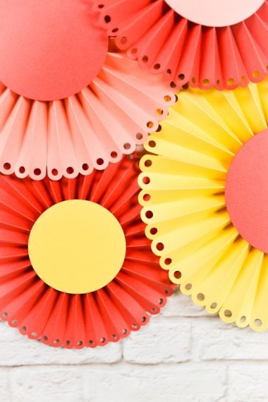 Create these gorgeous paper rosettes for a baby shower, bridal shower or wedding. I will show you how to do it using the Cricut Scoring Wheel.