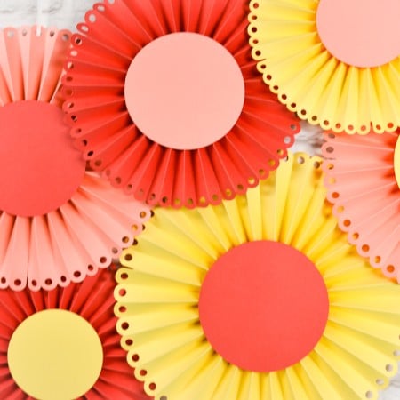 Create these gorgeous paper rosettes for a baby shower, bridal shower or wedding. I will show you how to do it using the Cricut Scoring Wheel.