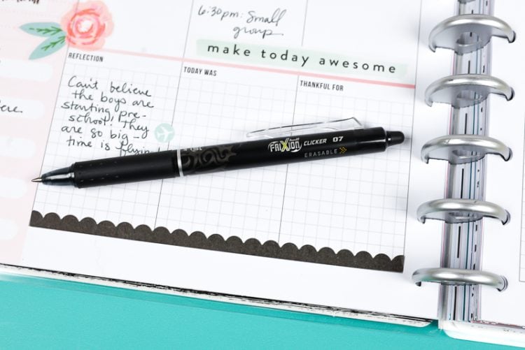 A close up of a pen on top of a weekly planner